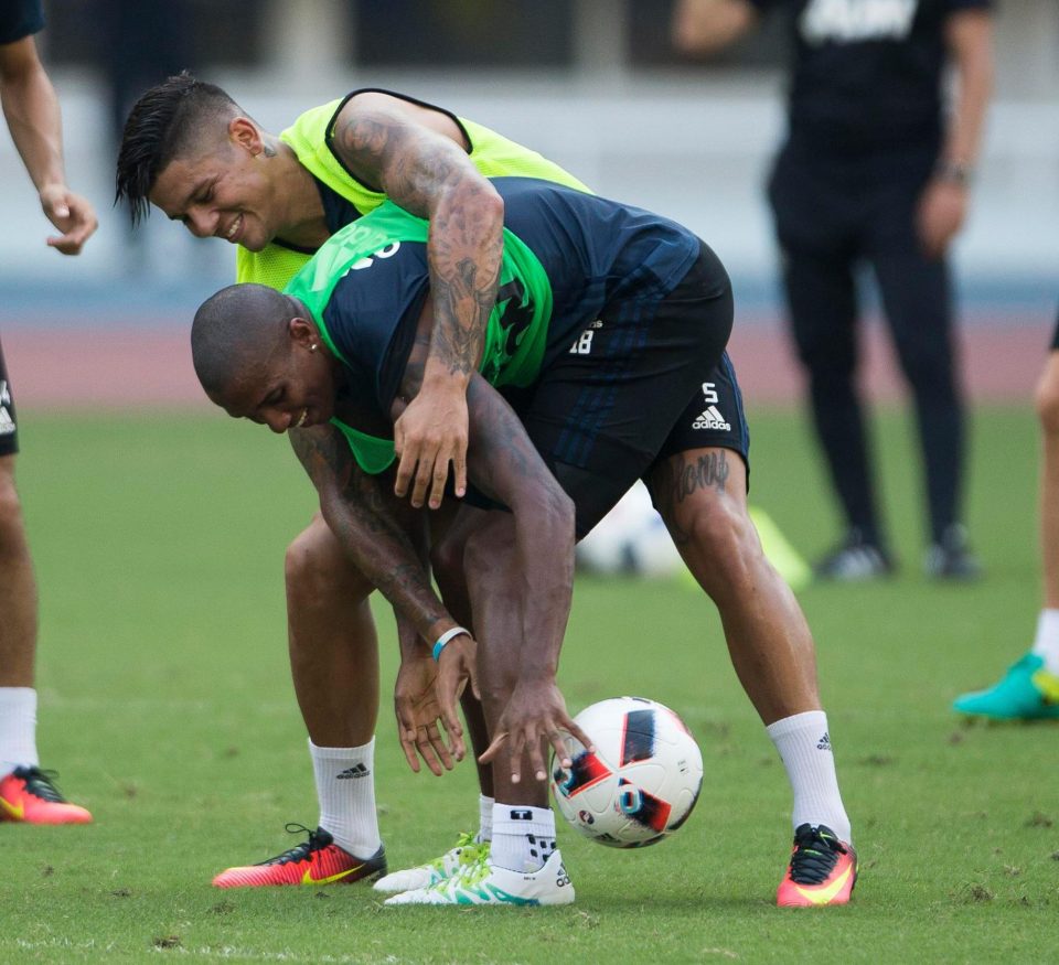  Young and Marcos Rojo clown around in a United training session