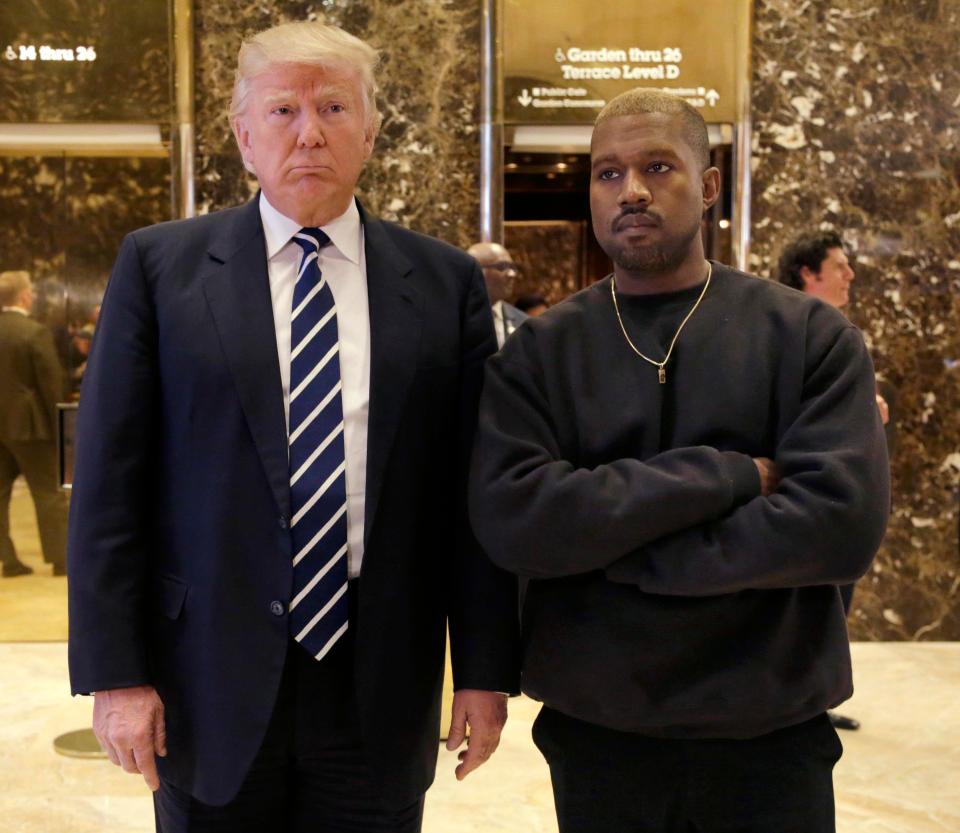  President-elect Donald Trump and Kanye West pose for a picture in the lobby of Trump Tower in New York after meeting publicly for the first time