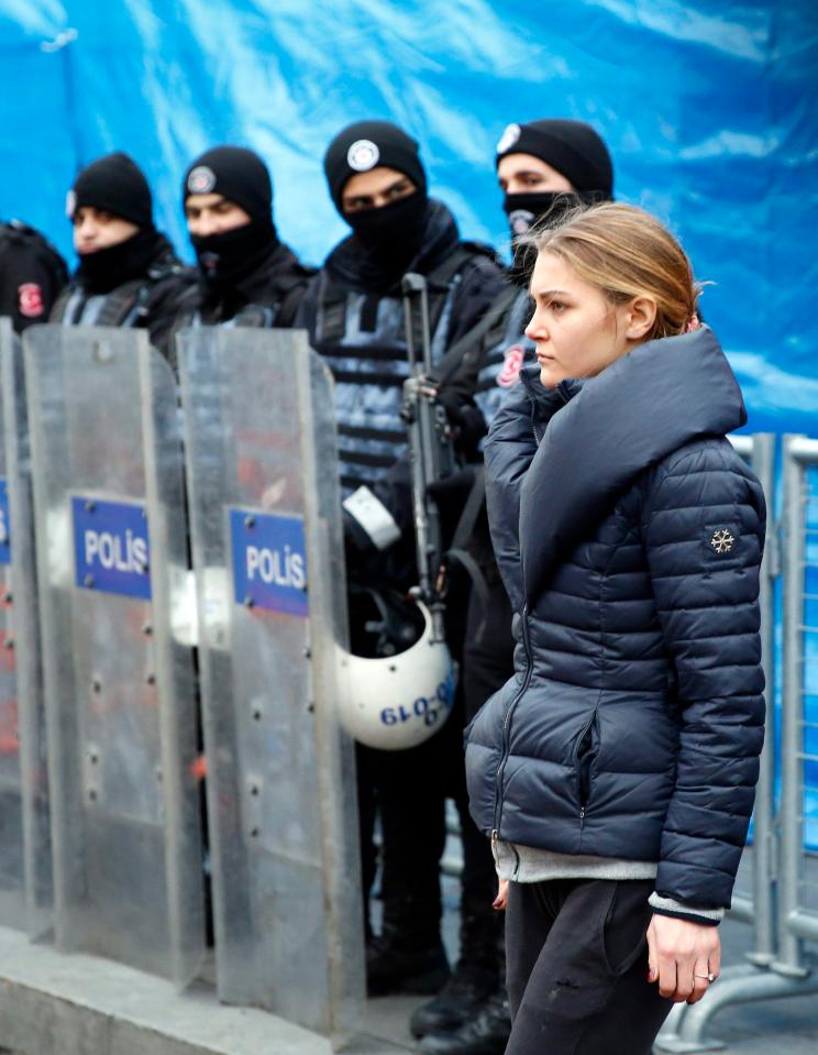  A female survivor waits to retrieve her belongings in front of Reina