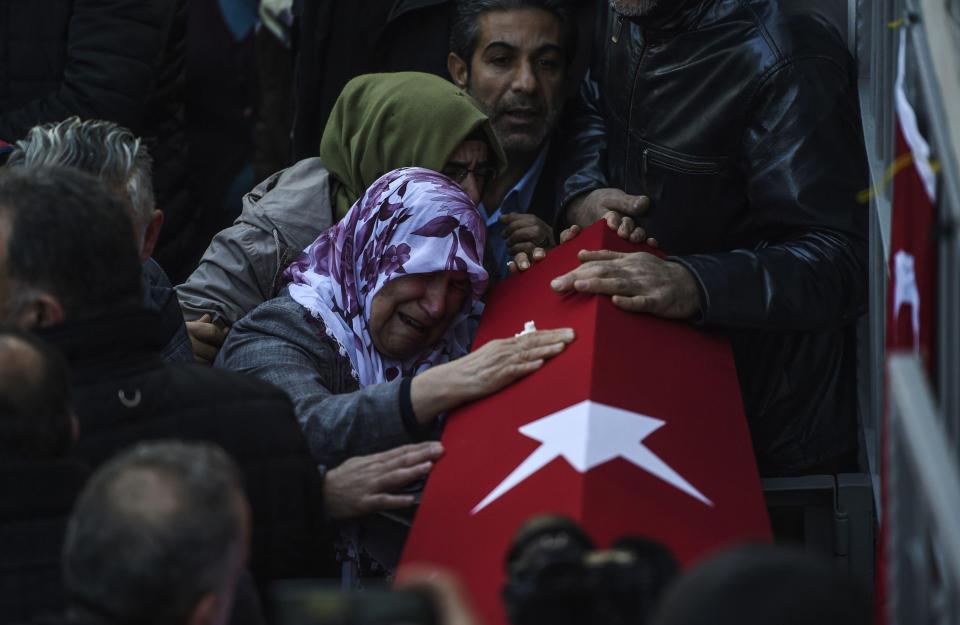  Relatives mourn security member Fatih Cakmak, 35, who died in the Reina attack