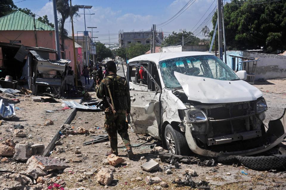  A soldier stands by after a suicide bomb attack in Somalia