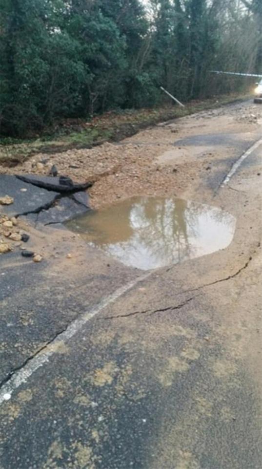  A huge sinkhole in the street was revealed after the water subsided