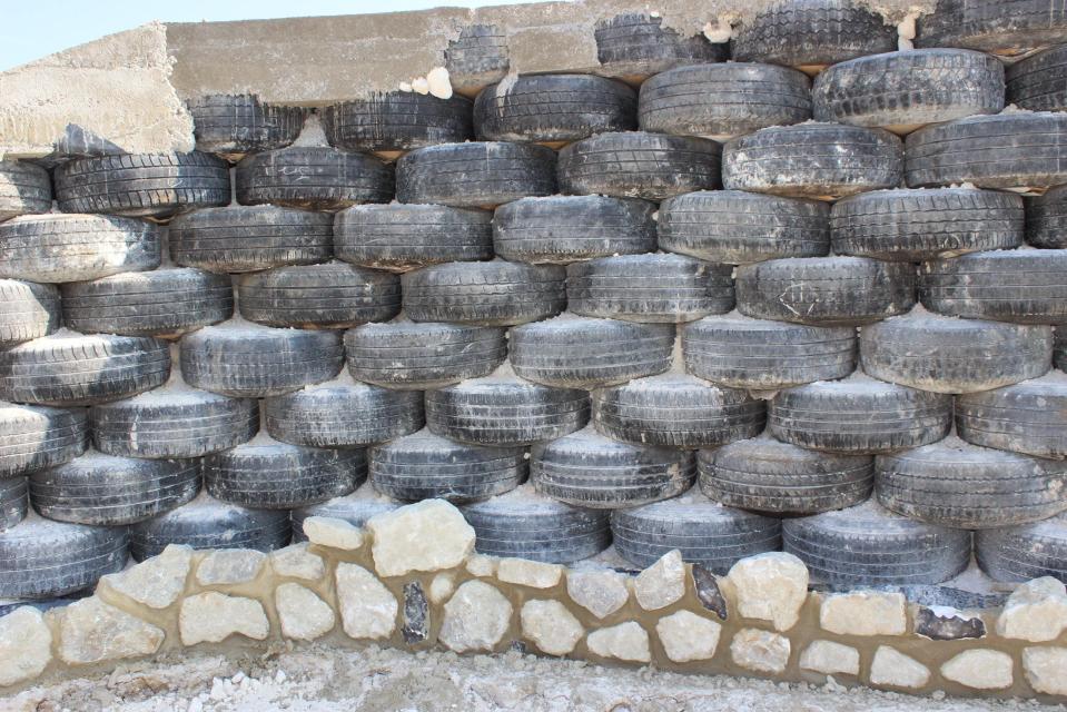  The eco-house features walls made from 800 recycled car tyres filled with chalk, covered in London clay and clad in Kentish ragstone and flint