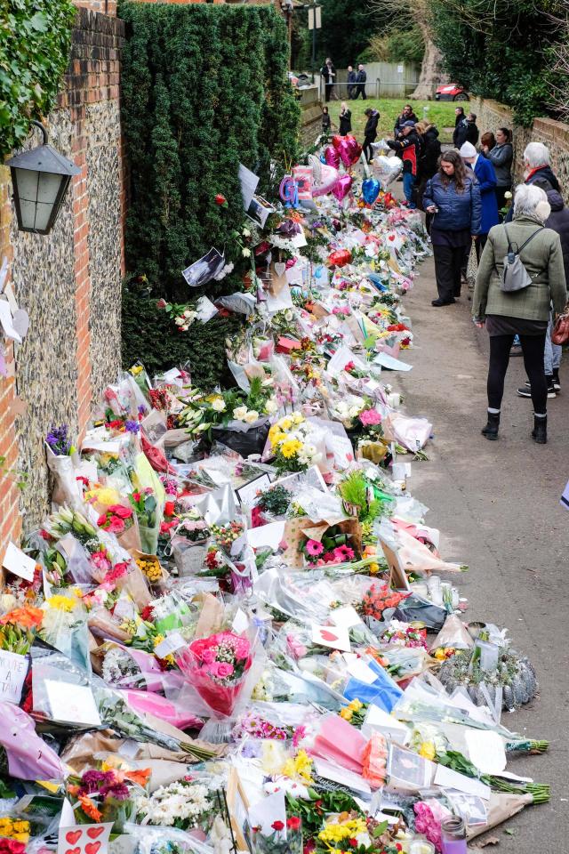  Fans have been leaving flowers outside the house in Oxfordshire where George's body was found