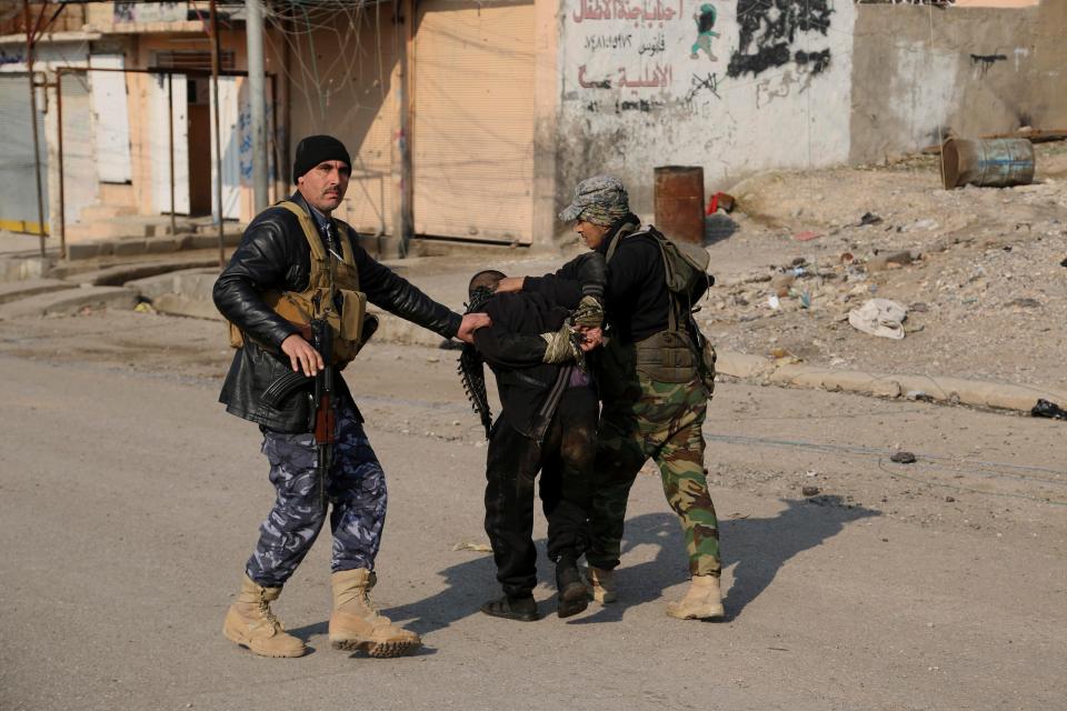  Iraqi soldiers arrest a suspected ISIS fighter trying to flee Mosul