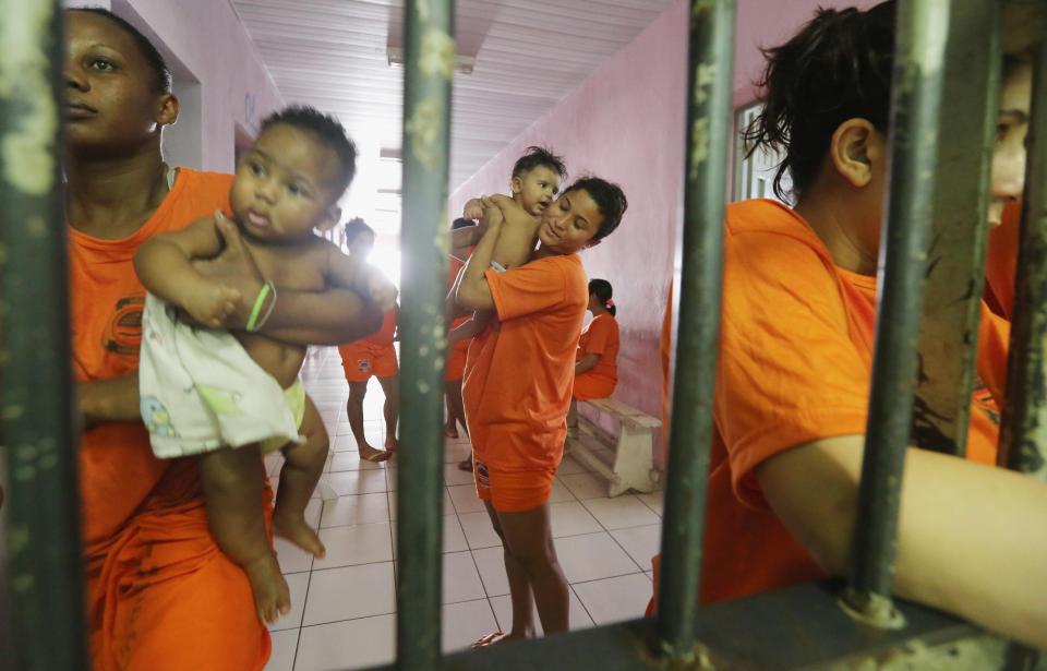  Female inmates gather with babies as they greet visitors in the jail where children live with their convict mothers