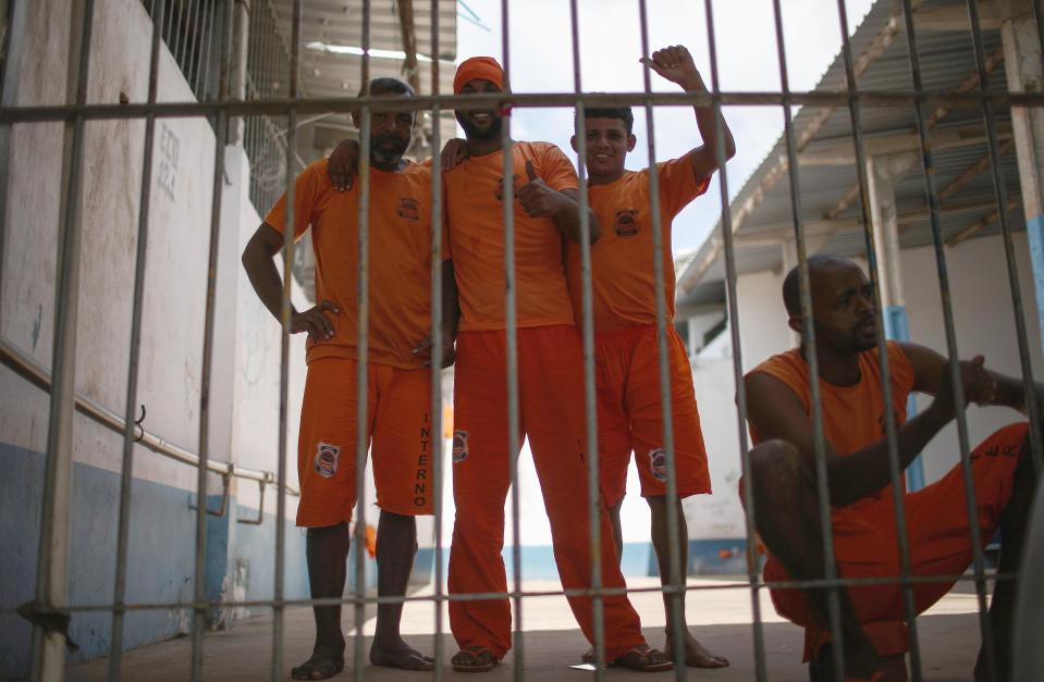  Rare smiles are raised by orange clad inmates at one of Brazil's biggest prisons