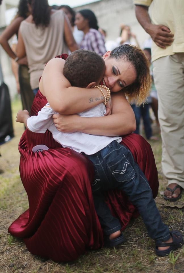  An inmate contestant hugs her visiting brother at the annual beauty pageant at the Talavera Bruce women's prison on November 24, 2015 in Rio de Janeiro