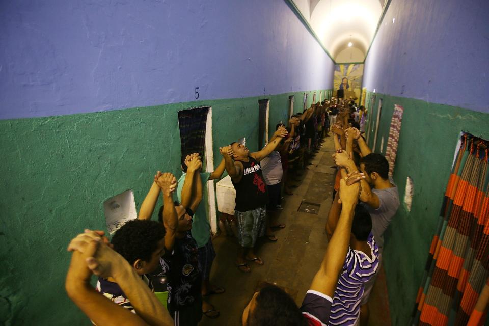  Detainees pray in the overcrowded Desembargador Raimundo Vidal Pessoa penitentiary