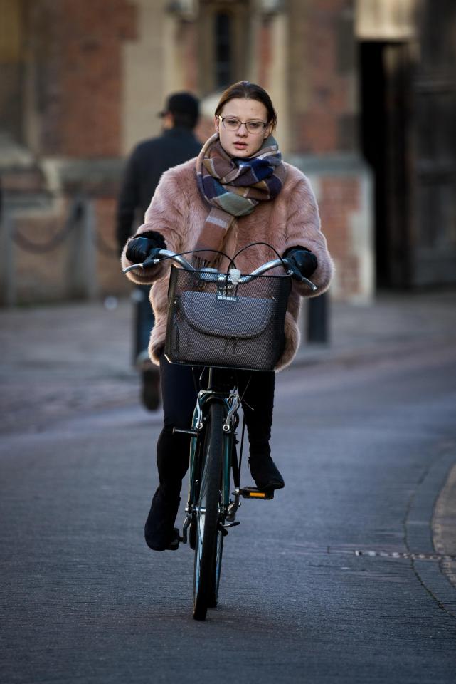  A cyclist wraps up against the cold in Cambridge today