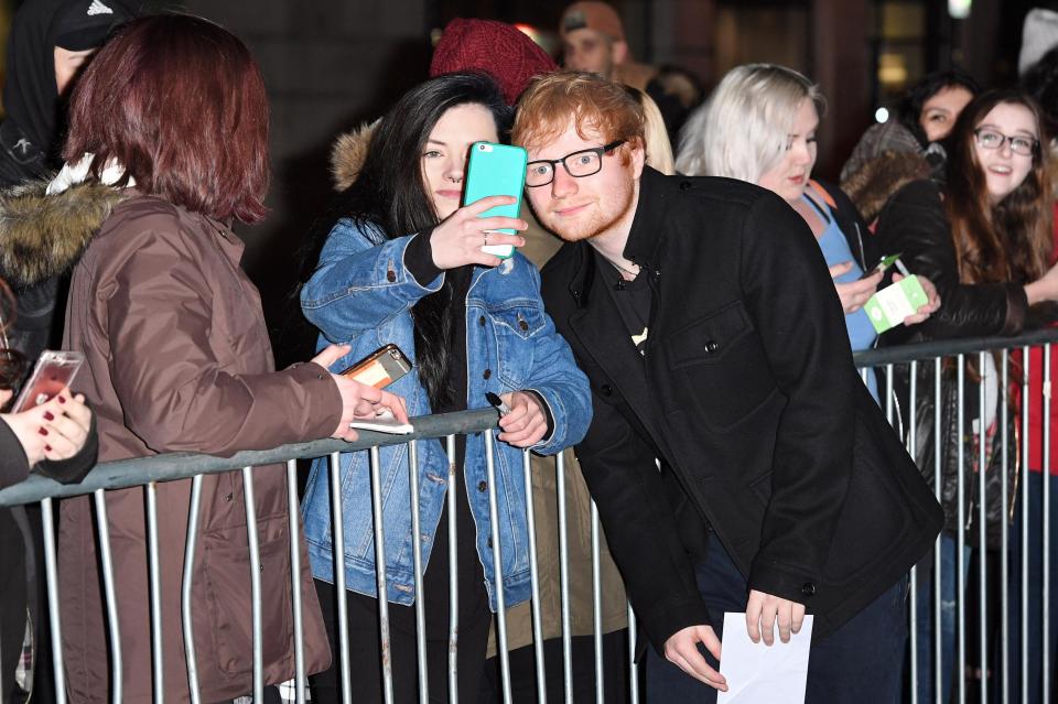  The singer greeted fans outside Radio 1 before he went on air at 7am