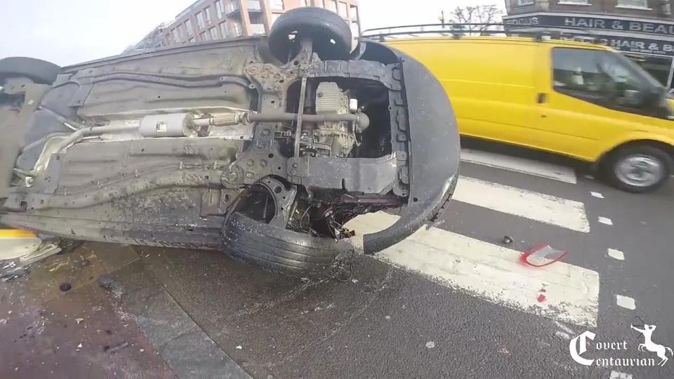  The man's car had flipped at a zebra crossing and was dangerously left overturned