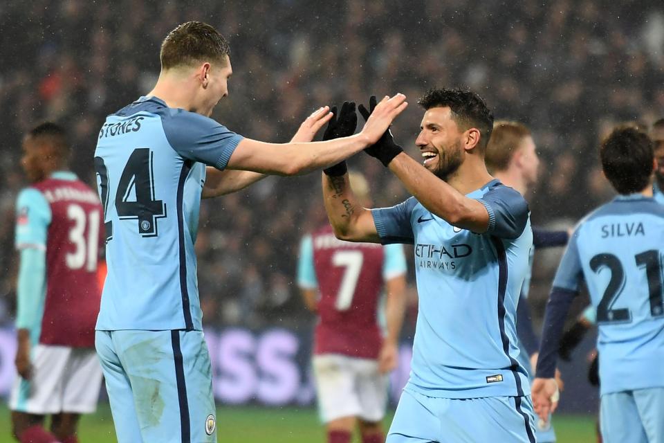  Sergio Aguero celebrates his fine finish with John Stones