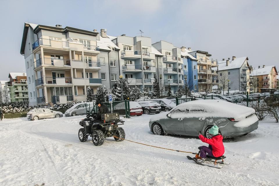  A father pulls his son along on a sled after a heavy fall of snow in Gdansk, Poland