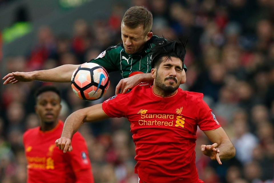  Plymouth midfielder David Fox leaps to challenge Emre Can in the air