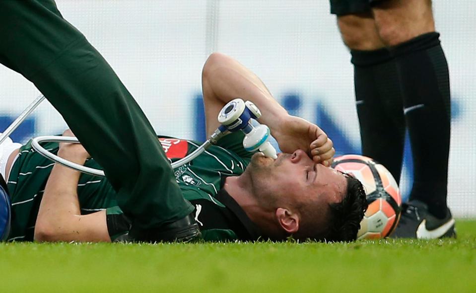  Gary Miller receives oxygen on the pitch before he was carried off on a stretcher