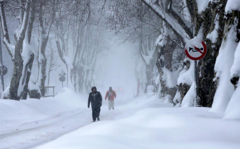  People walk during heavy snow at Sariyer district in Istanbul, Turkey