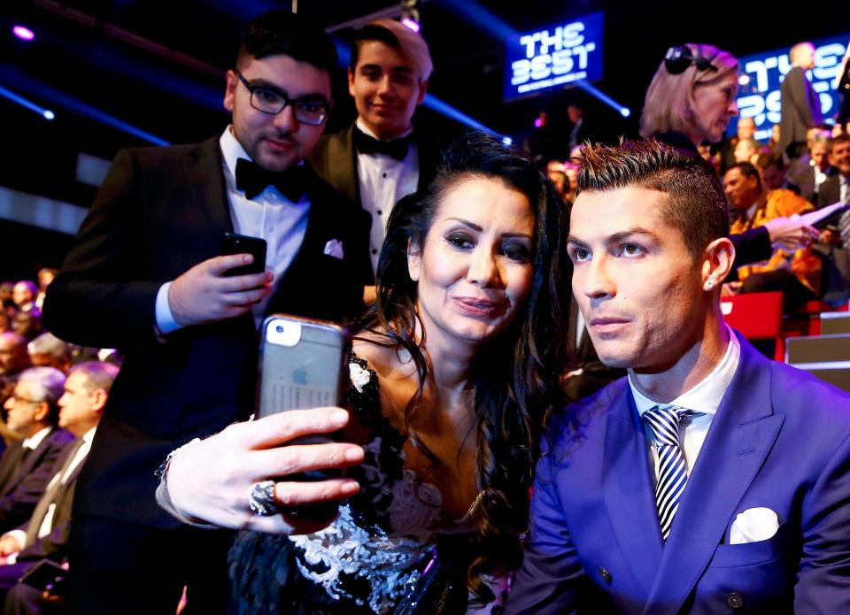  A queue of excited fans line up to take selfies with Real Madrid superstar Cristiano Ronaldo