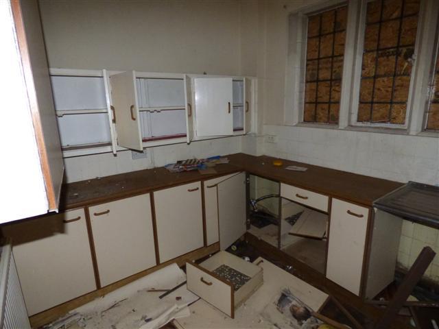  Photos of the property's interior show it in a dire state - with the kitchen needing significant updating