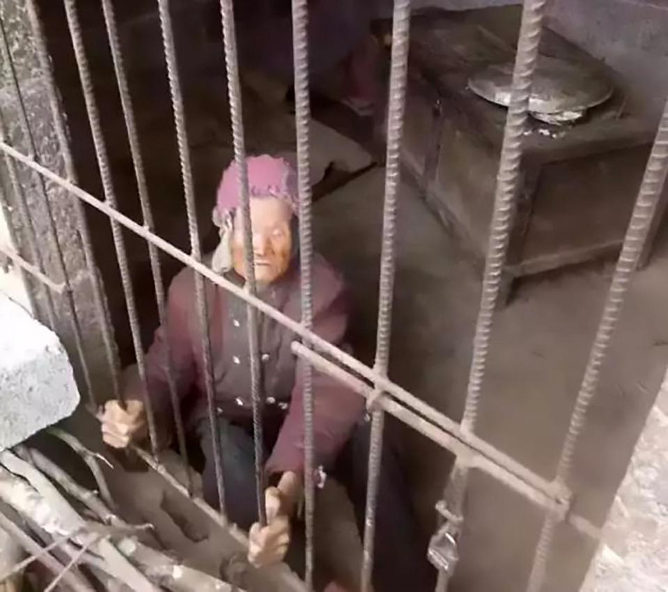  The 92-year-old identified only as Yang is pictured behind metal bars inside the pigsty