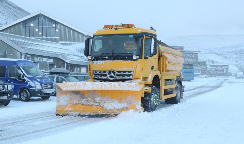  A snowplough gets to work in Aviemore, near Scotland, yesterday