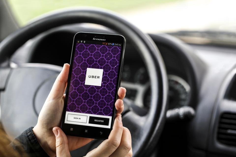  Uber customers hail drivers by using the firm's mobile phone app