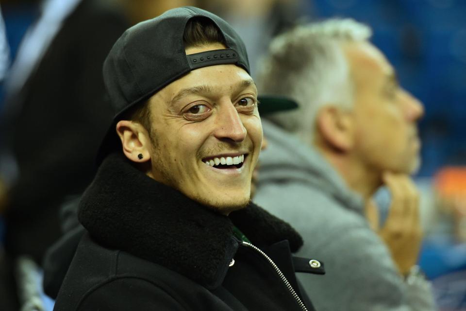  Ozil watches the NBA game at London's O2 Arena on Thursday