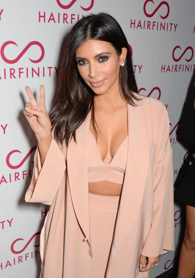  Kim Kardashian is playing with fire as she shows off her fingers