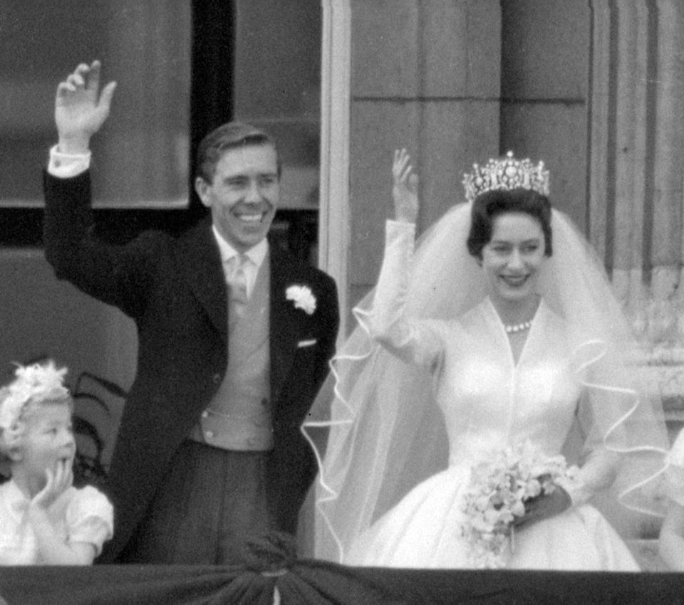  Princess Margaret and Lord Snowdon waving to the crowds on the balcony of Buckingham Palace after their wedding in 1960