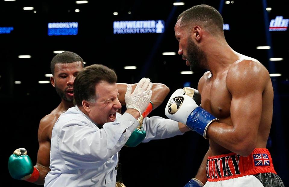  Badou Jack lands a fierce left hook on referee Arthur Mercante Jr during the fight