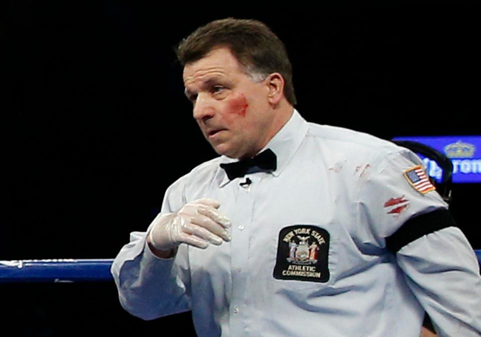  Referee Arthur Mercante Jr is left with a bloody cheek after feeling the full force of Badou Jack