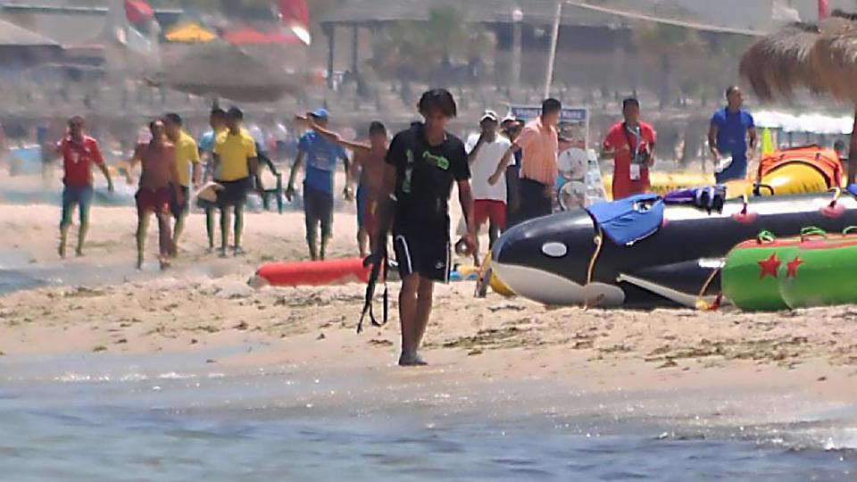  A chilling image of gunman Seifeddine Rezgui Yacoubi pictured on the beach during the attack