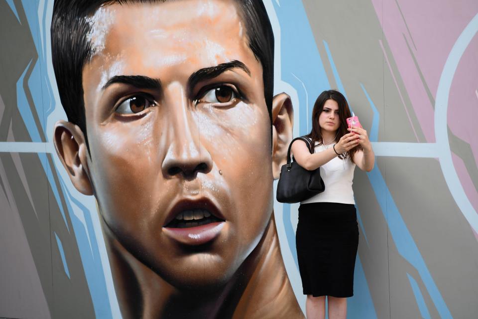  A woman takes a selfie in front of Cristiano Ronaldo graffiti near the Hotel de Ville in Paris, France.