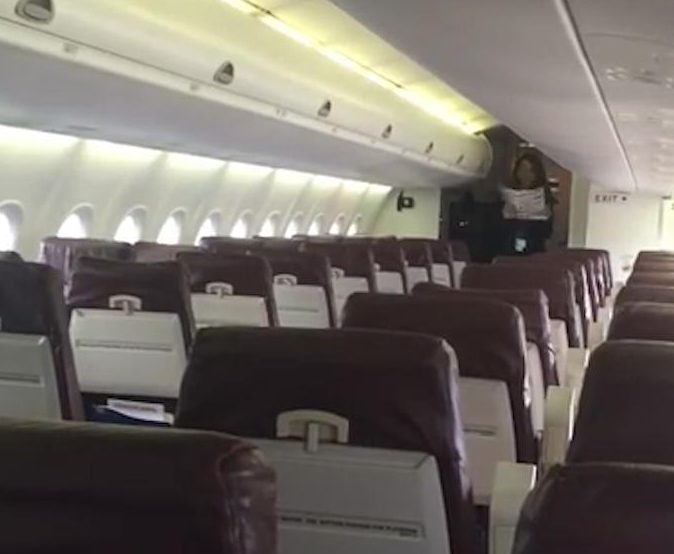  Steward stands at the opposite end of the plane to give the safety demonstration, despite the rows of empty seats