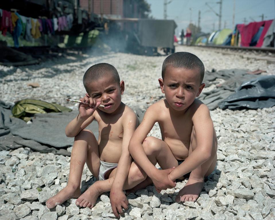  Castro Garcia's image of two boys sitting on the ground of Idomeni, Grece, featured in the series Foreigner: Migration into Europe 2015 - 2016