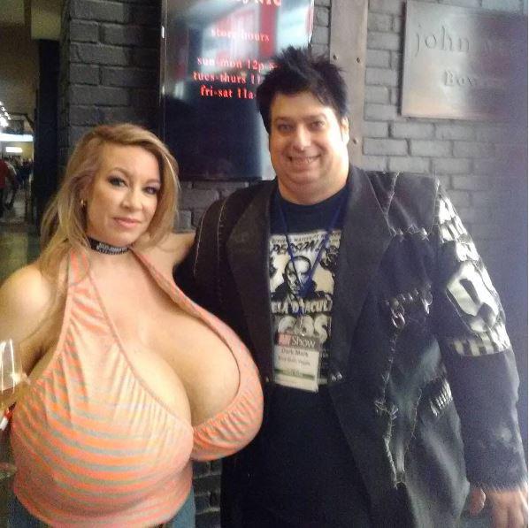  A porn fan looks pleased as punch as he poses next to his sex icon