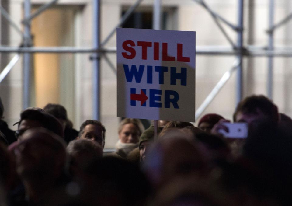  A protester holding a pro-Hillary Clinton sign