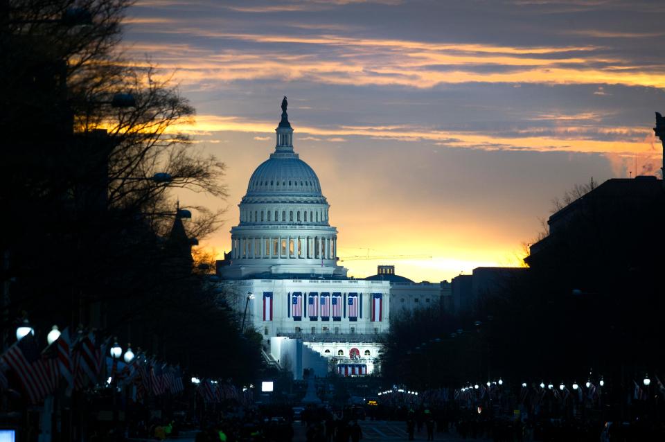  The sun rises behind the Capitol in Washington