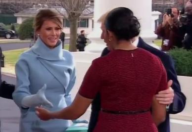  Melania Trump goes to shake Michelle Obama's hand - while the outgoing First Lady goes in for a kiss