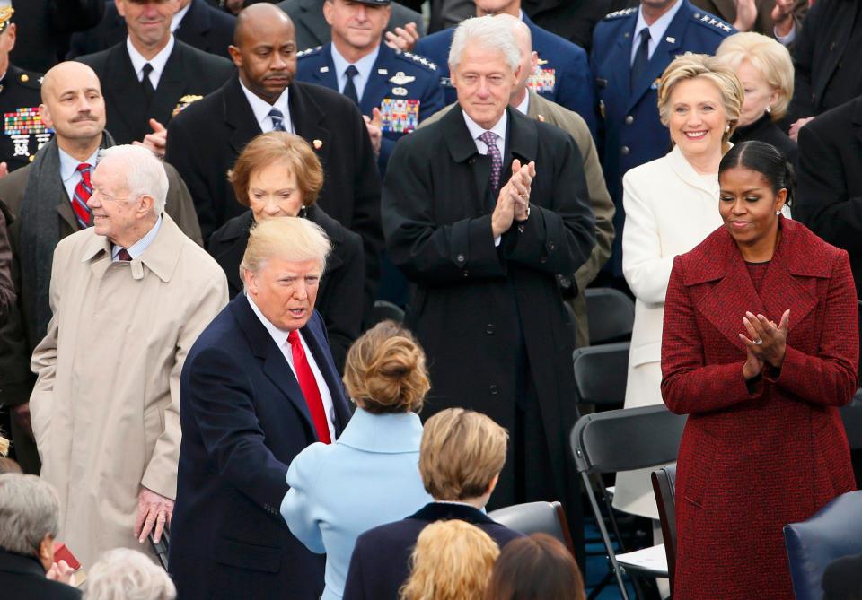  The former President was seated behind and to the left of the First Lady