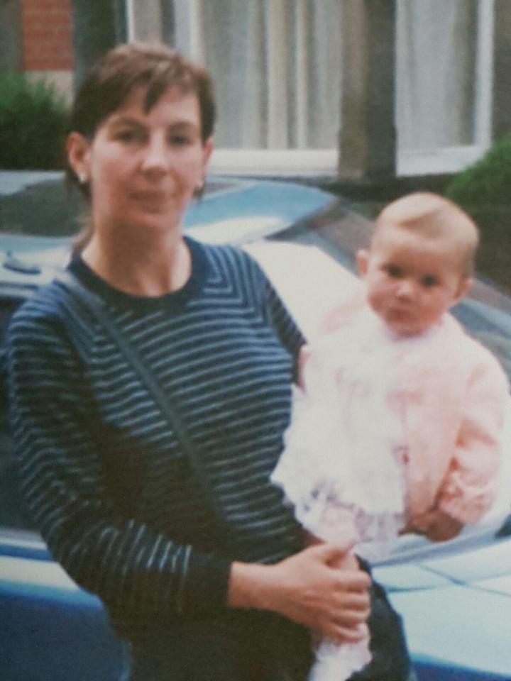  Chloe as a baby in the arms of her mum at their home