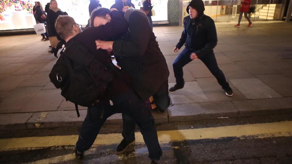  Two men,believed to be a Trump protester and a Trump supporter wrestled in the street