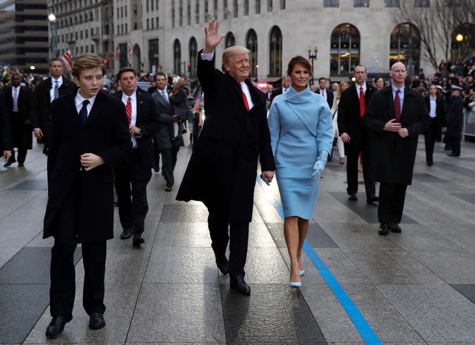  The man's hands appear to be frozen as he watches over the Trump family