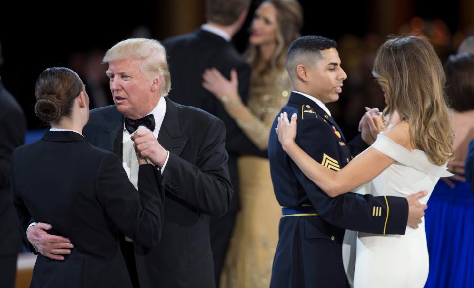  US President Trump dances with US Navy Petty Officer Second Class Catherine Cartmell while First Lady Melania Trump pairs up with with US Army Staff Sergeant Jose Medina during the Salute To Our Armed Services Ball,