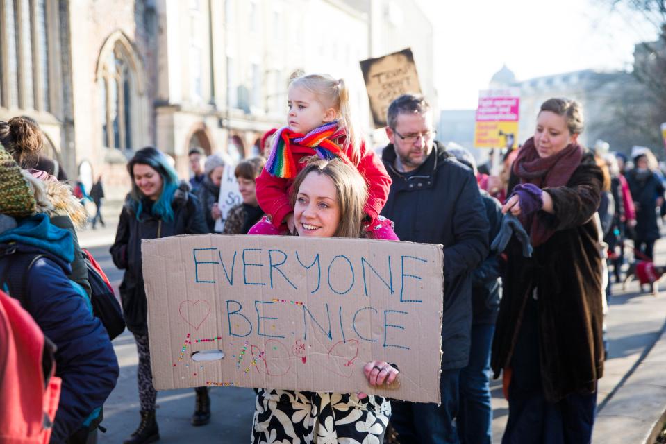  Hundreds of people held handmade posters with anti-Trump messages