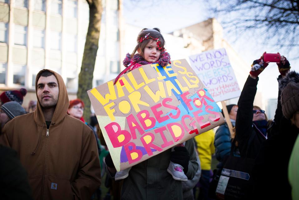  A little girl is being held up in the air as she joins the march in London