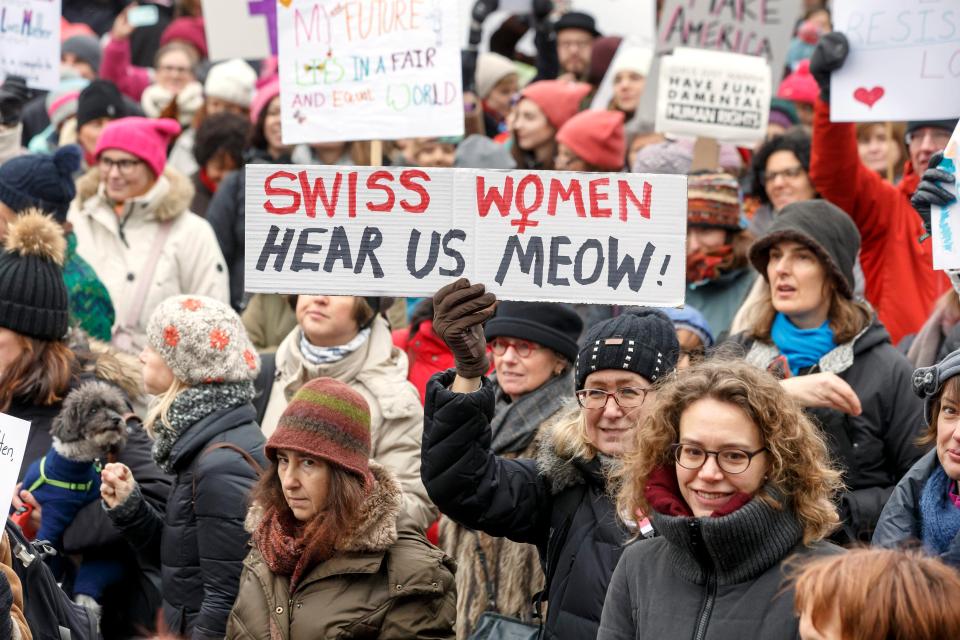  Protesters hold placards during the Women's March rally in Geneva, Switzerland