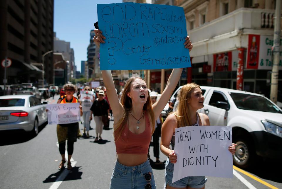  Women in Cape Town hold up signs in defence of press freedom and women's rights