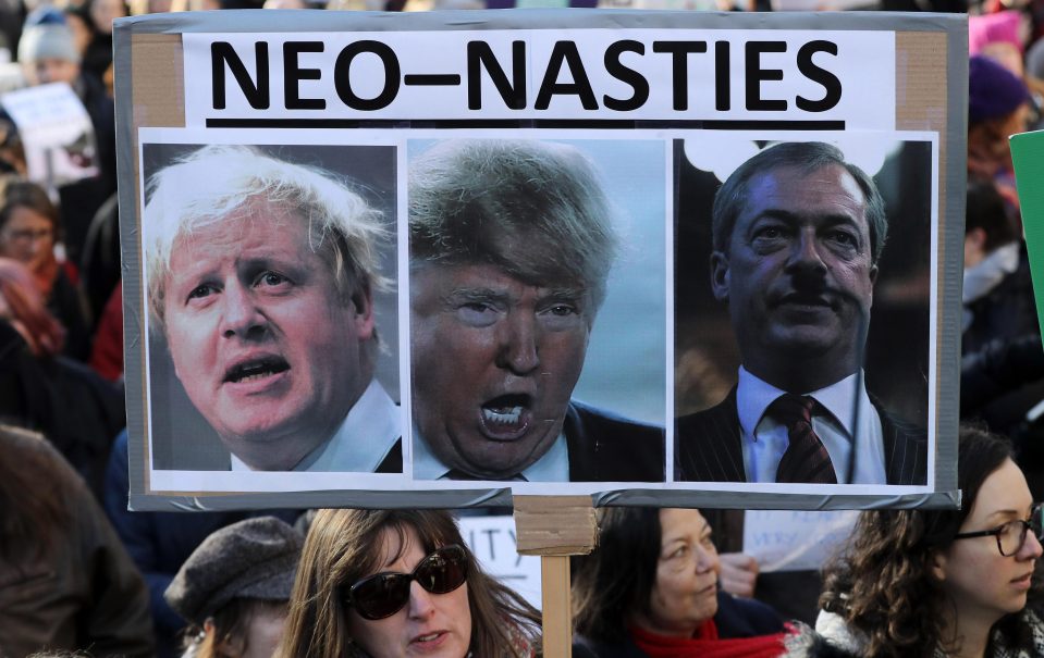  A protester holds up her placard showing Boris Johnson, Donald Trump and Nigel Farage, calling them neo-nasties