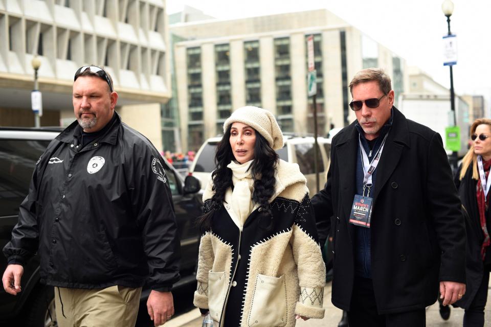  Cher arrives for the Women's March on Washington on Saturday surrounded by security guards